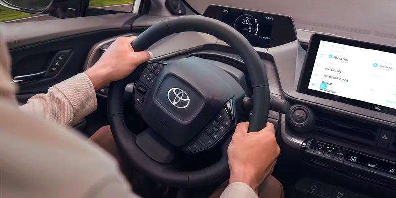 A man holding the wheel of a 2024 Toyota Prius Near Bishop, CA